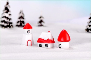 Macro view of miniature Christmas house set with snow-covered roof and mushroom cottage