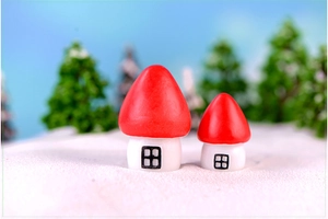 Macro view of miniature red mushroom house ornaments in a winter snowy scene