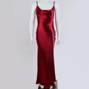 Detail view of red silk backless dress with cowl neck on white mannequin
