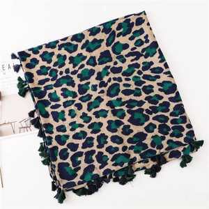 Classic leopard print cotton linen scarf with tassels shown in a flat lay style