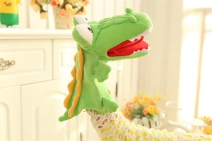 Detail of soft green crocodile hand puppet showing red mouth and white felt teeth