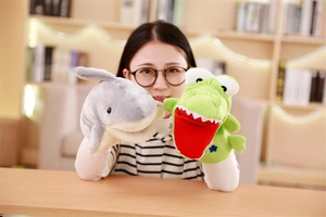 Detail of plush shark and crocodile hand puppets for storytelling and role play