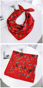 Detail of red square silk scarf featuring artistic zebra and heart patterns for women