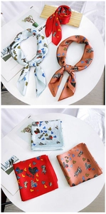 Detail showing various silk-like square scarves with zebra and heart patterns in multiple colors