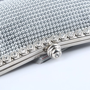 Silver evening clutch bag featuring intricate beadwork and sparkling rhinestones detailing