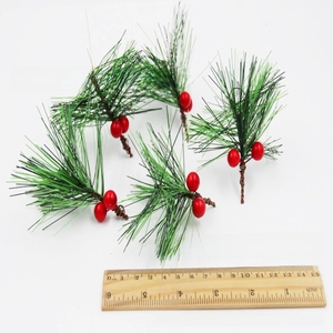 Detail view of 5cm artificial pine needles and red berries for Christmas DIY crafts