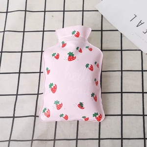 Detail of pink PVC hot water bottle with strawberry print on checkered background
