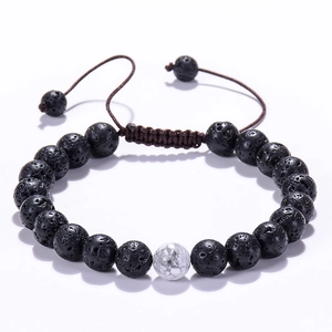 Macro shot of 8mm lava rock and white turquoise beads on an adjustable woven bracelet