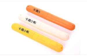 Three travel toothbrush cases in orange, beige and yellow with portable hanging loops