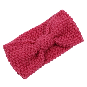Rose red chunky knit headband with central twist knot in minimalist flat lay design