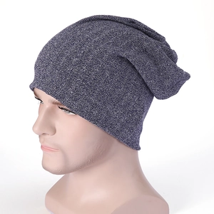 Detail of grey mélange knit beanie showing soft texture and relaxed slouchy fit on model