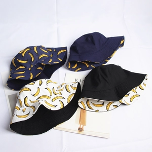 Reversible canvas bucket hats with banana patterns in navy, black and white colors