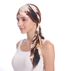 Detail of floral patterned milk silk headscarf showing the knot design and fabric texture