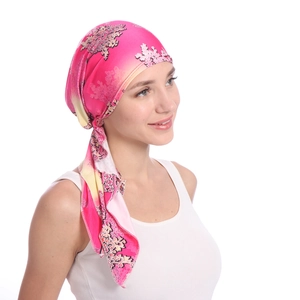 Detail of floral pattern on pink satin headscarf for women with silky texture