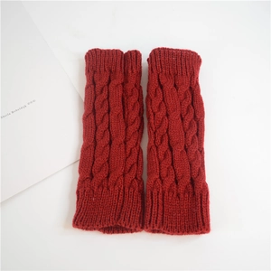 Detail view of red cable-knit fingerless gloves with soft textured warm fabric