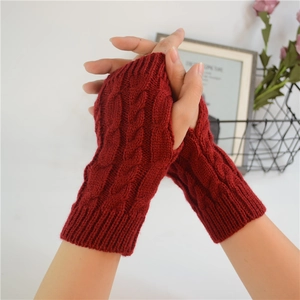 Detailed knit texture of wine red cable knit fingerless gloves with thumb hole