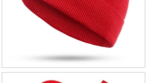 Close-up of red winter knit beanie showing thick texture and folded cuff detail