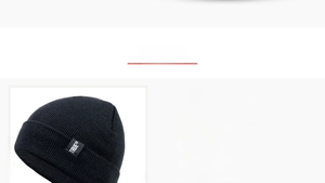Detail view of a black cotton knit beanie featuring a TRUE woven label and 55-60cm size info
