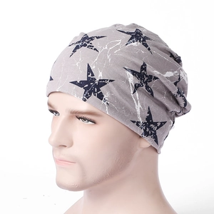 Detailed texture of grey knit beanie featuring navy star patterns and marble print design