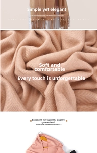 Detail view of khaki and pink cashmere blend scarves featuring soft fringe edges and premium texture