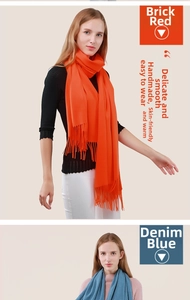 Detail showing solid color scarves in brick red and denim blue with fringe trim