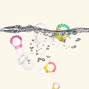 Silicone baby fruit feeders in pink, yellow, and green splashing in water