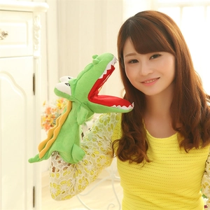 Green plush crocodile hand puppet with open red mouth and yellow fins for kids storytelling