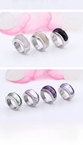 Detailed close-up of faceted crystal rings in multiple colors with stainless steel bands