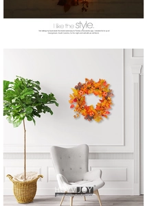 Autumn wreath with maple leaves and pumpkins hanging on white wall in a modern living room