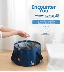 Detail of portable folding basin with silver lining showing water for washing hands