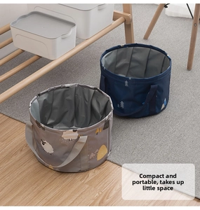 Detail view of foldable travel basins with sheep and forest patterns in a home setting