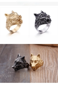 Detailed macro view of vintage wolf head steel rings in golden and silver finishes