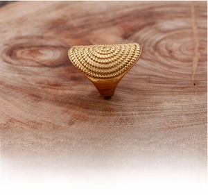 Detailed macro view of retro stainless steel ring with layered circular beaded texture