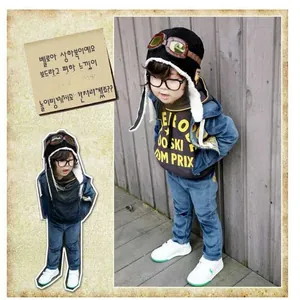 Detail of dark blue velour kids tracksuit with aviator hat and decorative goggles