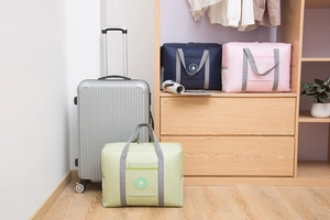 Macro view of pastel travel organizer bags with trolley sleeve on a suitcase