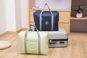 Foldable travel bag detail showing the navy blue and light green water-repellent fabric