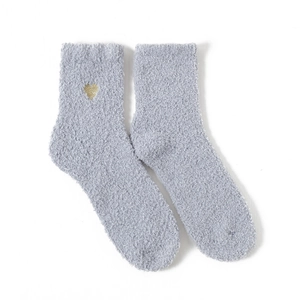 Macro shot of grey coral fleece crew socks featuring gold heart embroidery on the ankle