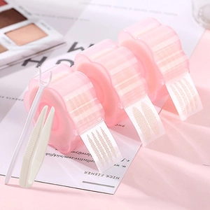 Three rolls of pink double eyelid tape with applicator tools in petal-shaped cases