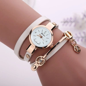 Detail of white wrap-around leather watch with rose gold angel pendant and rhinestones