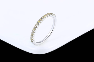 Detailed close-up of a silver ring featuring micro-pave yellow zircon gemstones