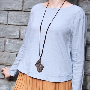 Ethnic vintage wooden pendant necklace with irregular hollow design on long woven cord