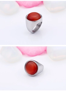 Detail of a titanium steel ring featuring a large round red opal gemstone on a silver band