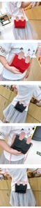 Detail of cute rabbit crossbody bags in red and black with embroidered bunny faces