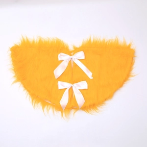 Golden plush Christmas tree skirt with white silk bows on a clean white background