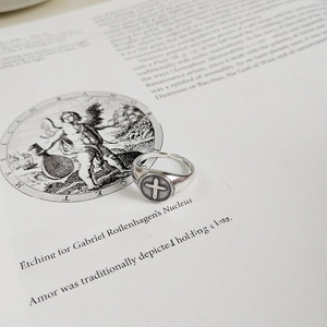Macro shot of 925 silver ring featuring an engraved cross design and S925 hallmark