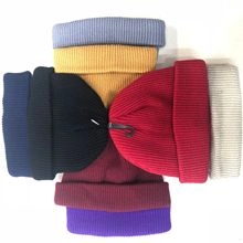 Detailed stack of multi-color ribbed knit beanies in various bright colors for winter