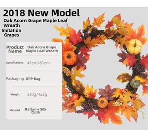 Close-up of fall wreath featuring maple leaves, acorns, grapes and mini pumpkins