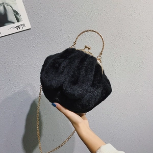 Black faux fur rabbit ear handbag with gold chain strap and metal frame clasp