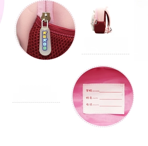 Detail of pink backpack featuring custom silicone zipper pull and inner name tag
