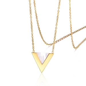 Detailed view of golden mermaid scale pendant necklace with white shell inlay and chain